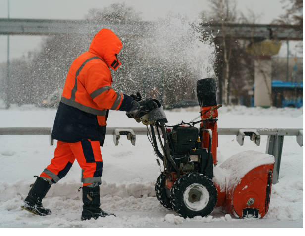Wheel loader with bucket moving snow