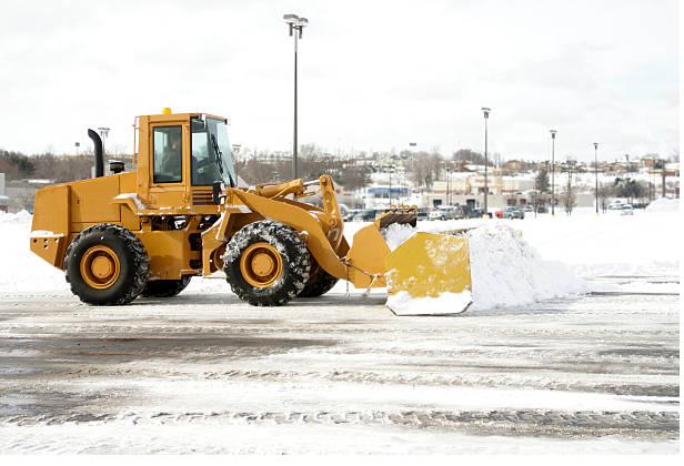 Wheel loader pushing a snow pile across a parking lot
